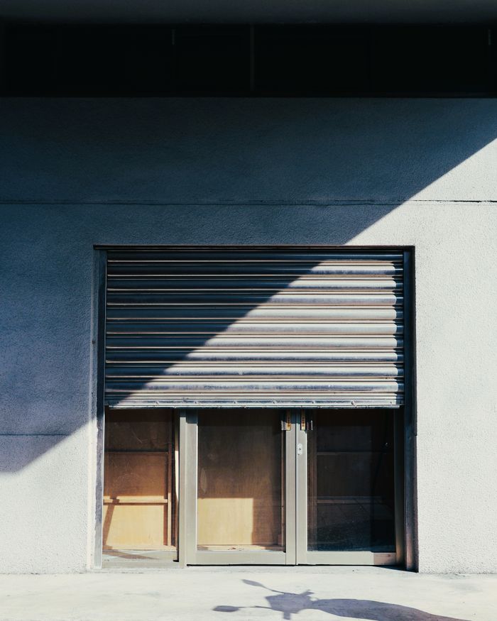 Services A shuttered industrial doorway with strong light and shadow contrast in Taiwan.